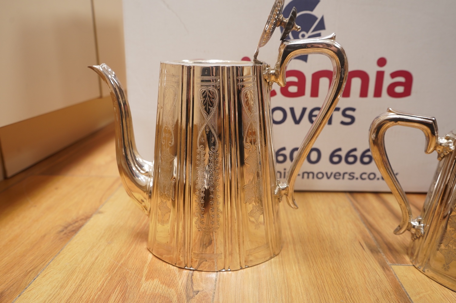 A collection of plated items, including a pair of candle holders, coffee pot, a jasper ware biscuit box and similar pot without cover